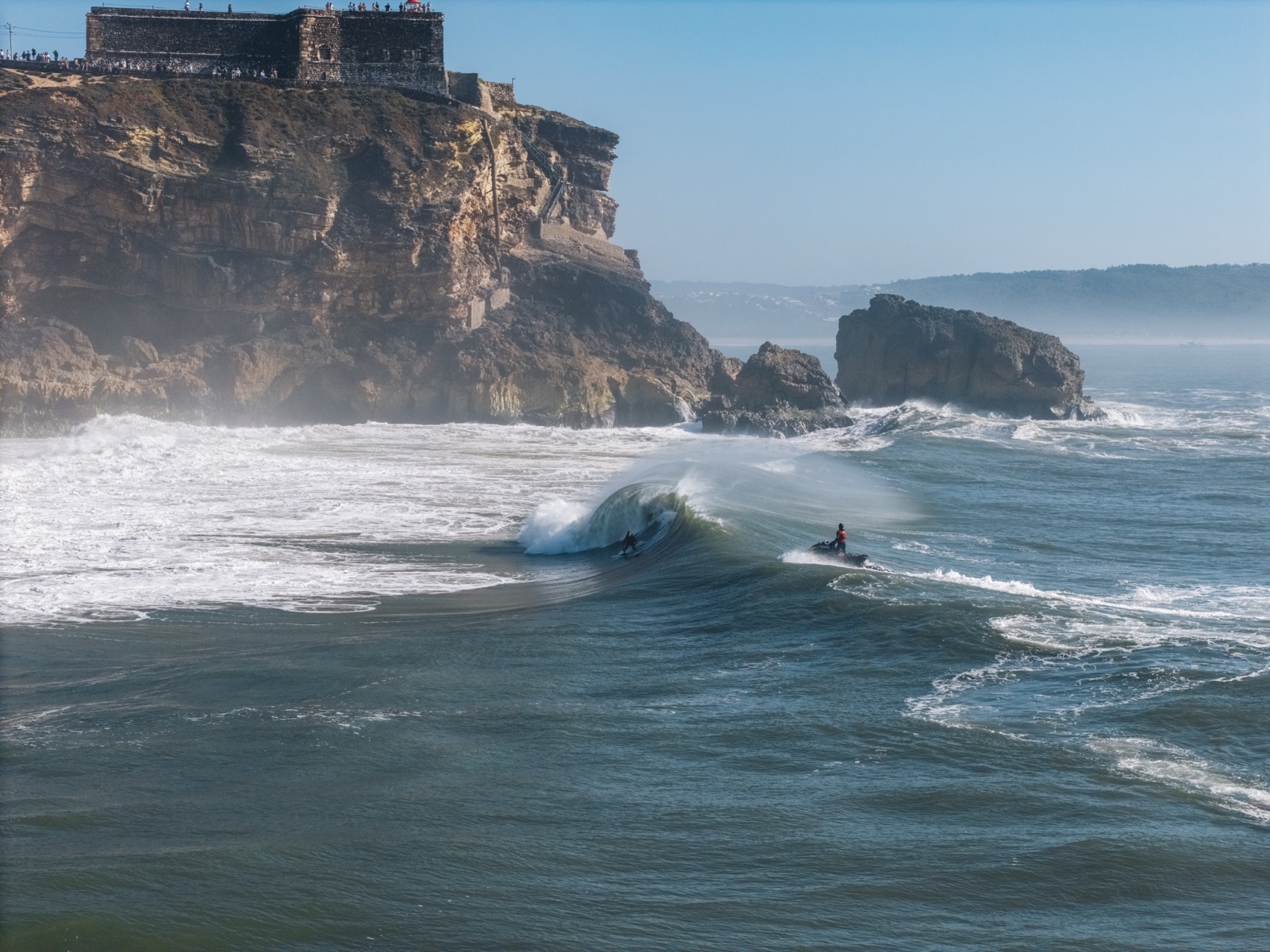 The winter Atlantic breaking heavy beneath dark cliffs